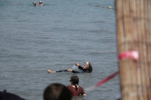 a Muslim woman floating in the Dead Sea