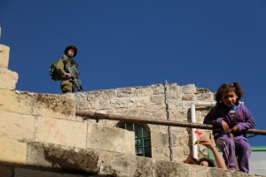 a sniper and a Palestinian girl, excited for photos 